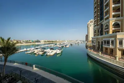 a view of a river with boats docked next to buildings at Palm Jumeirah Lifestyle - Elegant Waterfront Studio in Dubai