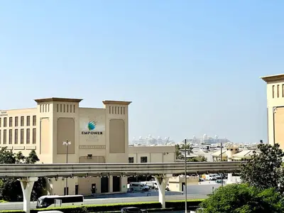 a large building with a bridge in front of it at Palm Jumeirah Lifestyle - Elegant Waterfront Studio in Dubai