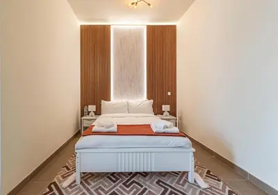a white bed in a room with a window at Luxurious apartment with Burj Khalifa & Canal Views in Dubai