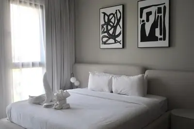 a white bed with a stuffed animal sitting on top of it at 1BR Madinat Jumeirah Living in Dubai