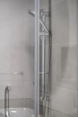 a shower with a glass door next to a shower at 1BR Madinat Jumeirah Living in Dubai