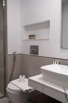 a white bathroom with a sink and a toilet at 1BR Madinat Jumeirah Living in Dubai