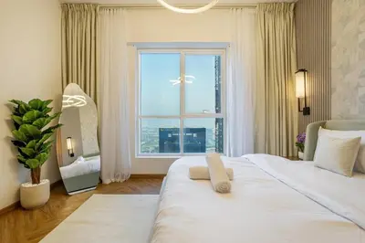 a bedroom with a large white bed with a large window at Luxury Condo 3 BR in Dubai Marina Sulafa 4004 in Dubai