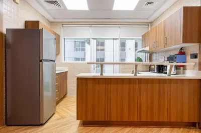a kitchen with a stainless steel refrigerator and wooden cabinets at Luxury Condo 3 BR in Dubai Marina Sulafa 4004 in Dubai