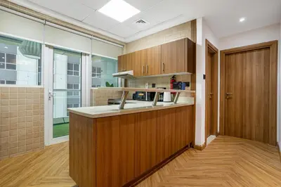 a kitchen with wooden cabinets and a sink at Luxury Condo 3 BR in Dubai Marina Sulafa 4004 in Dubai