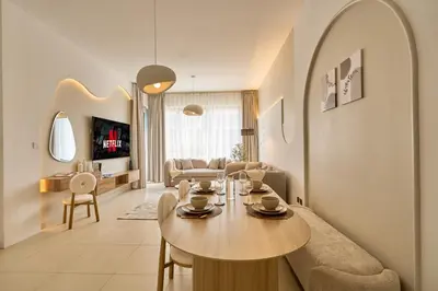 a living room with a table and a couch at Luxury 1BR Downtown Modern Urban Stay in Dubai