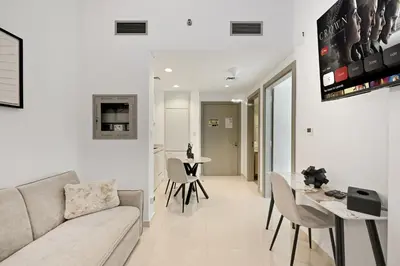 a living room with a couch and a table at Zada 1BR High Floor - Stunning View 1min Downtown and 2min to Metro in Dubai