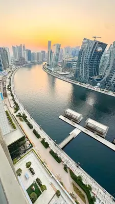a view of a city with a river and buildings at Stylish Dubai Stay in Dubai
