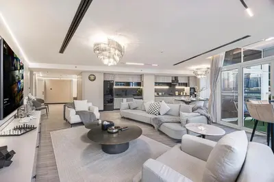 a living room with a couch and a table at Skyline Views with Waterfront & Marina Walk - 3 BDR Apartment in Dubai