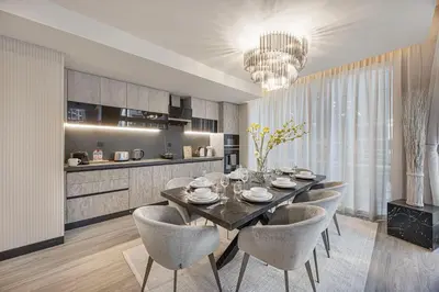 a dining room with a table and chairs and a kitchen at Skyline Views with Waterfront & Marina Walk - 3 BDR Apartment in Dubai