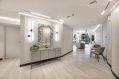 a hallway with a mirror and a table and chairs at Skyline Views with Waterfront & Marina Walk - 3 BDR Apartment in Dubai