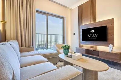 a living room with a couch and a tv at STAY BY LATINEM Luxury 1BR Plus Holiday Home CB 1412 Near Burj Khalifa in Dubai
