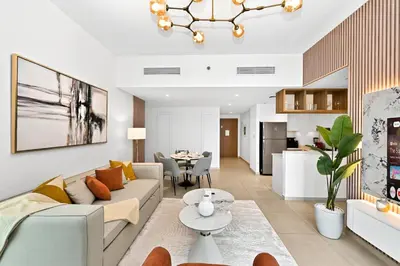 a living room with a couch and a table at Golden Stays - Stunning Downtown 2Br with Full Burj Views & Free Parking in Dubai