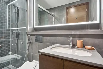 a bathroom with a sink and a shower at STAY BY LATINEM Luxury 1BR Holiday Home CC 3007 Near Burj Khalifa in Dubai