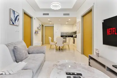 a living room with a couch and a tv at Modern 2Bed with Canal Views 7 Mins to Burj Khalifa in Dubai