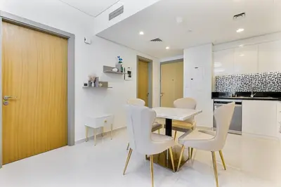a dining room with a table and chairs in a kitchen at Modern 2Bed with Canal Views 7 Mins to Burj Khalifa in Dubai