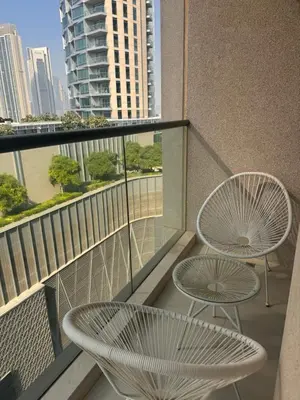 a balcony with two chairs and a table on a building at Prime Downtown 3 BDR-2 mn to Dubai Mall in Dubai