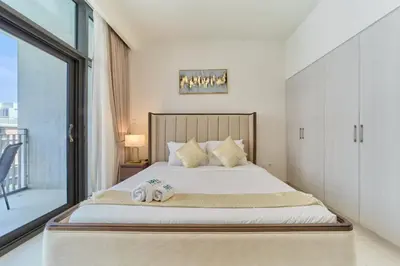 a bedroom with a bed with two towels on it at fam Living Chic 1BR Retreat in Dubai Hills Estate in Dubai