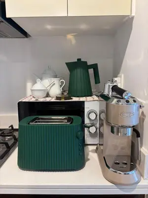 a kitchen with a green coffee maker on a counter at Mama's Crib Dubai in Sabkhah
