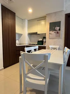 a kitchen and dining room with a white table and chairs at Mama's Crib Dubai in Sabkhah