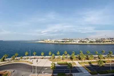 a view of the ocean and a city with palm trees at Daniels 3BR at La Cote with Full Sea View in Dubai