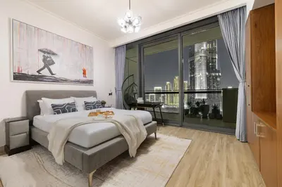 a bedroom with a large bed and a large window at 3BR Direct Access to Dubai Mall and Burj Khalifa in Dubai