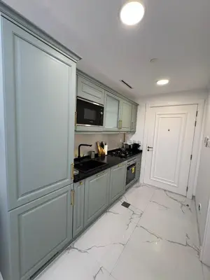 a kitchen with marble floors and a white counter top at Vincitore Benessere - Arjan by Golden Casa in Dubai