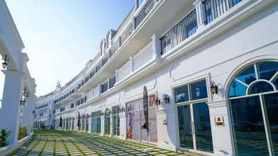a large white building with windows and a sidewalk at Vincitore Benessere - Arjan by Golden Casa in Dubai