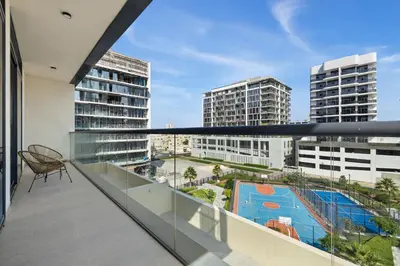 a balcony with a view of a pool and buildings at Modern 1BR Near World Trade Center Metro in Dubai