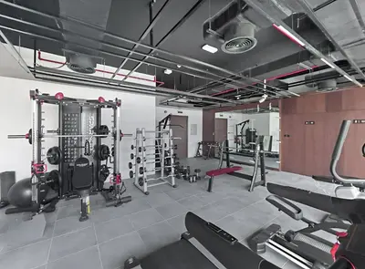 a gym with several treadmills and weights at Modern 1BR Near World Trade Center Metro in Dubai