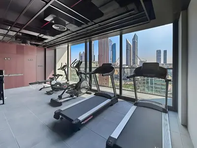 a gym with several treadmills and a view of the city at Modern 1BR Near World Trade Center Metro in Dubai
