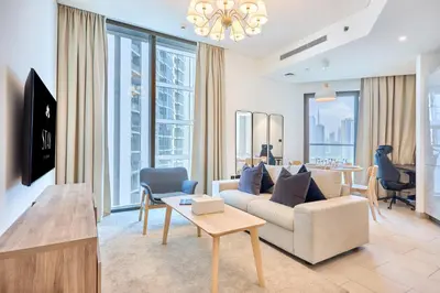 a living room with a couch and a table at STAY BY LATINEM Luxury 2BR Holiday Home W2013 near Downtown in Dubai