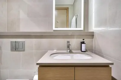 a bathroom with a sink and a mirror at STAY BY LATINEM Luxury 2BR Holiday Home W2013 near Downtown in Dubai