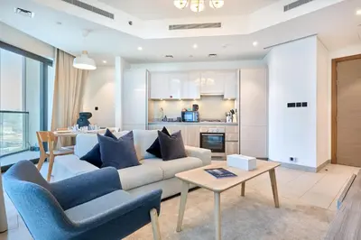 a living room with a couch and a table at STAY BY LATINEM Luxury 2BR Holiday Home W2013 near Downtown in Dubai