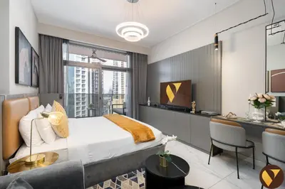 a bedroom with a king sized bed and a desk at Vogue Downtown Mag 318 near Burj Khalifa and Dubai Mall, Studio Apartment with Balcony and City View, Access to all Amenities in Dubai