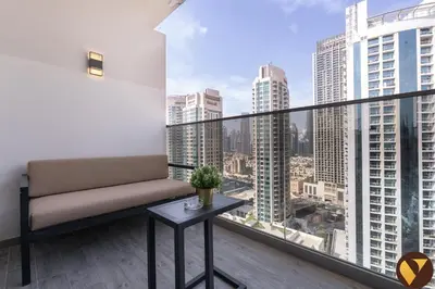 a balcony with a bench and a view of the city at Vogue Downtown Mag 318 near Burj Khalifa and Dubai Mall, Studio Apartment with Balcony and City View, Access to all Amenities in Dubai