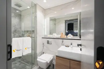 a bathroom with a toilet and a sink and a shower at Vogue Downtown Mag 318 near Burj Khalifa and Dubai Mall, Studio Apartment with Balcony and City View, Access to all Amenities in Dubai