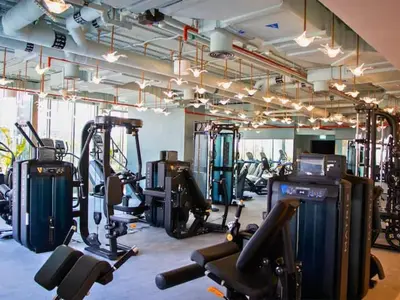 a gym with several treadmills and exercise bikes at Vogue Downtown Mag 318 near Burj Khalifa and Dubai Mall, Studio Apartment with Balcony and City View, Access to all Amenities in Dubai