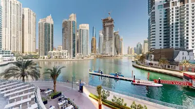 a river in the middle of a city with tall buildings at Vacationer l Lux 2 Bedroom Apartment with Marina & Skyline View Prime Location in Dubai