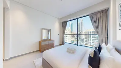 a bedroom with a large window with a view of the city at Vacationer I Premium 2 Bedroom Apartment I Close to DIFC & WTC I Central Location in Dubai