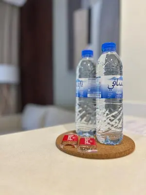 two bottles of water are sitting on a coaster at Modern Apartment in JVC in Dubai