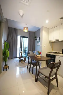 a kitchen and living room with a table and chairs at Joyful Journeys Downtown And Burj View Residence Business Bay One-Bedroom Apartment in Dubai