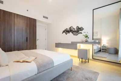a bedroom with a large white bed and a desk at Frank Porter - Rahaal 2 in Dubai
