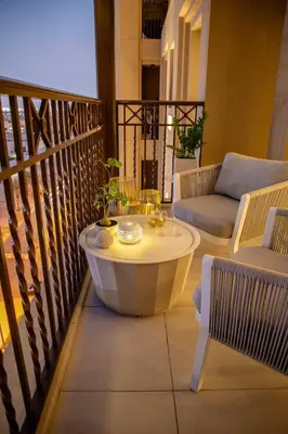 a balcony with a coffee table and a couch at Frank Porter - Rahaal 2 in Dubai