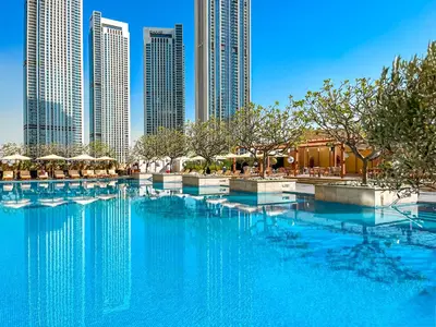 a large swimming pool in a city with tall buildings at 1BR Apt Kempinski Central Avenue Downtown Dubai in Dubai