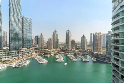 a group of boats in a harbor in a city at Luxury 1BR in LIV Marina with Canal Views in Dubai