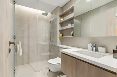 a bathroom with a toilet and a sink and a shower at Luxury 1BR in LIV Marina with Canal Views in Dubai