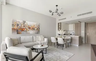 a white living room with a couch and a table at Luxury 1BR in LIV Marina with Canal Views in Dubai