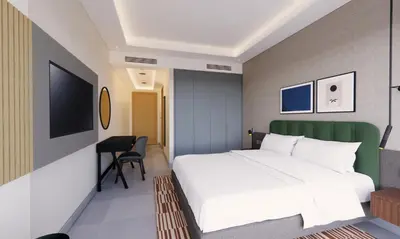a bedroom with a white bed and a desk at Marriott Executive Apartments Jumeirah Lakes Towers, Dubai in Dubai