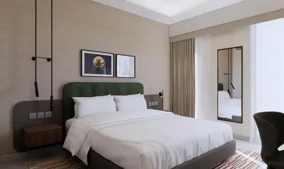 a bedroom with a large white bed and a chair at Marriott Executive Apartments Jumeirah Lakes Towers, Dubai in Dubai